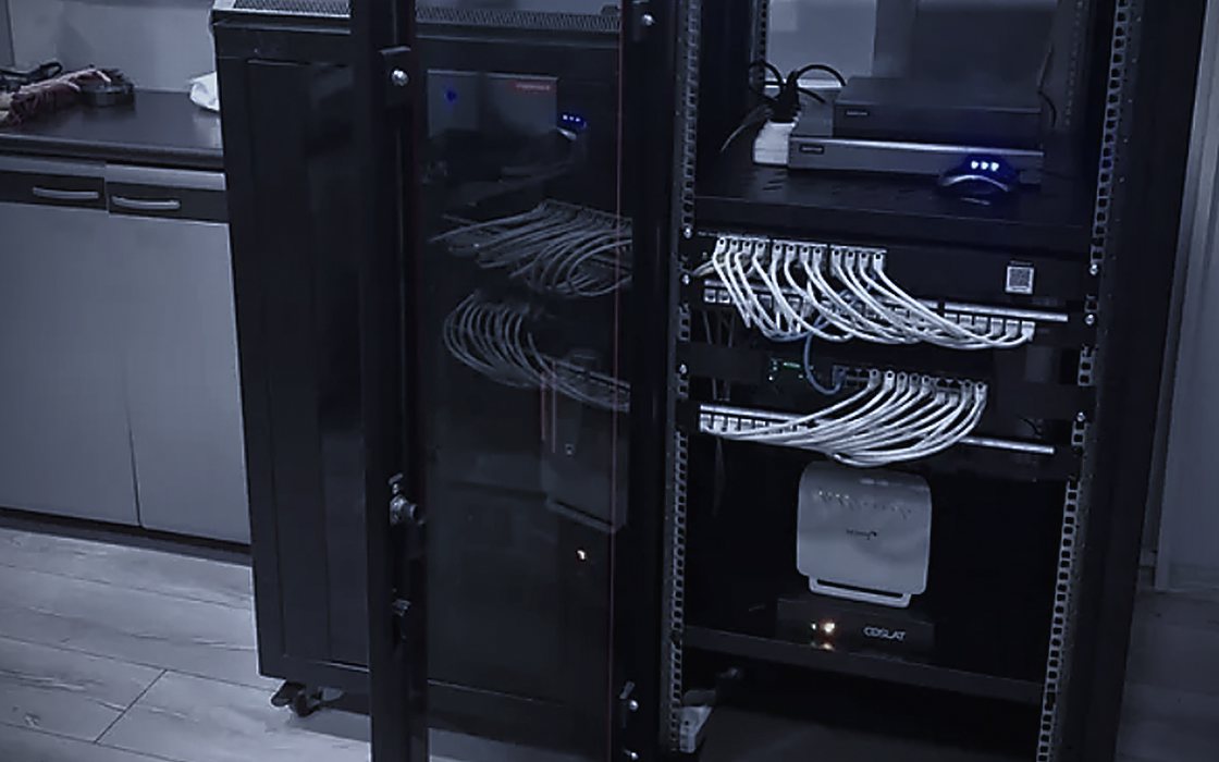 Siyah rack kabin içinde patch panel, switch ve Coslat güvenlik duvarı cihazı